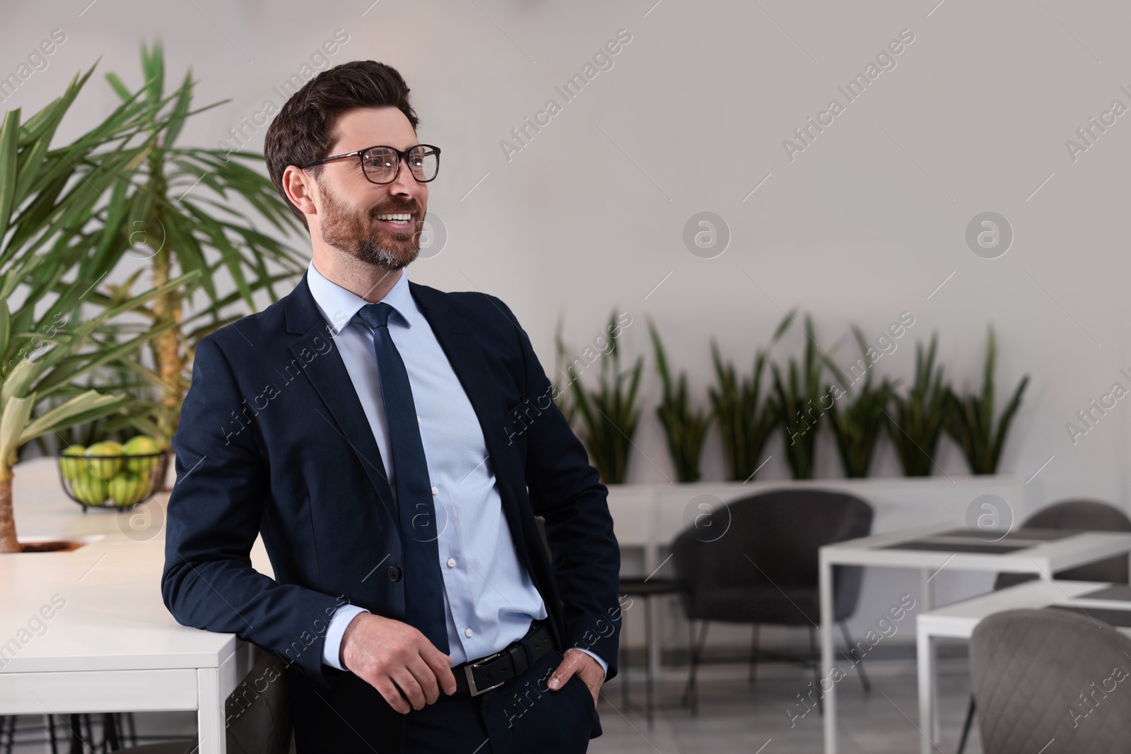 Photo of Happy real estate agent indoors. Space for text