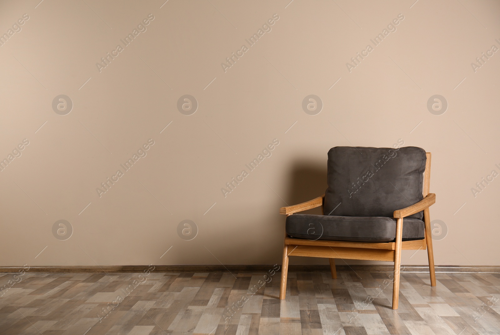 Photo of Stylish chair near color wall, space for text. Interior design