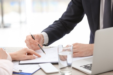 Young consultant working with client in office