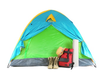 Photo of Colorful tent and camping equipment on white background