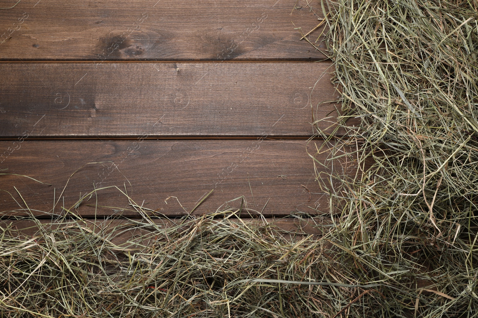 Photo of Frame made of dried hay on wooden table, top view. Space for text