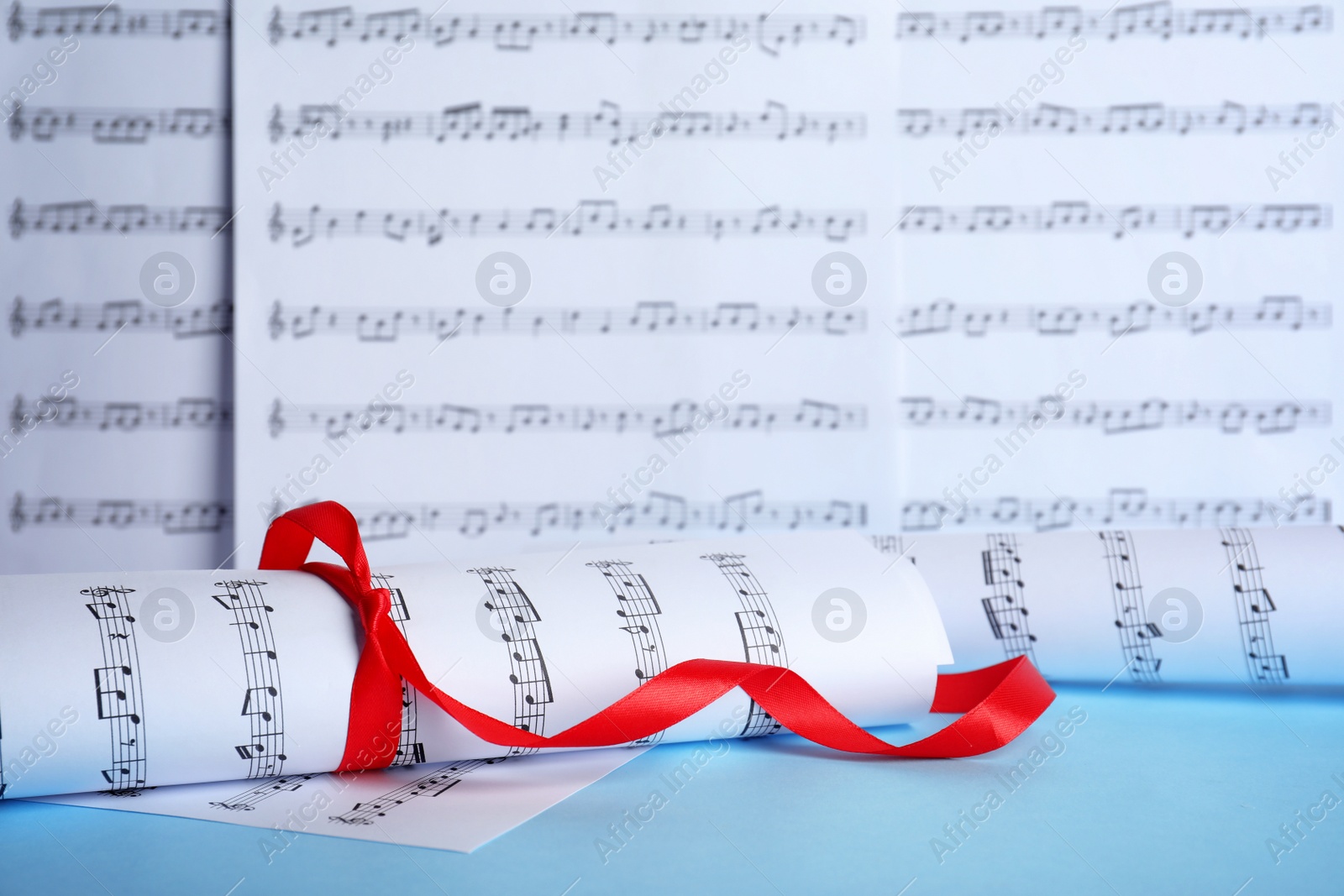 Photo of Sheets with music notes on table. Space for text