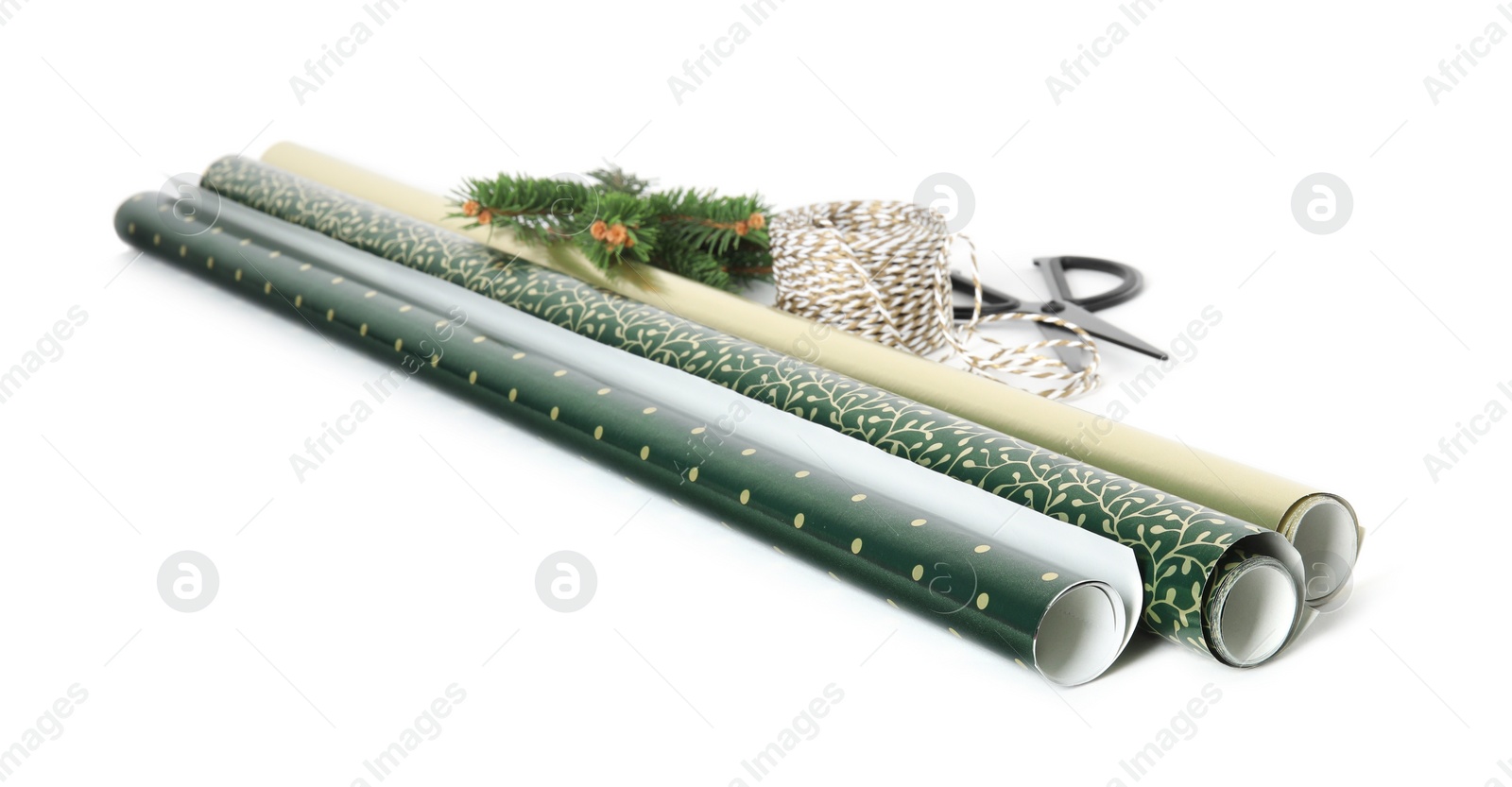 Photo of Wrapping paper rolls, rope, fir branches and scissors on white background