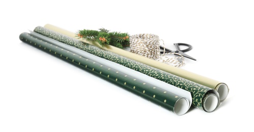 Photo of Wrapping paper rolls, rope, fir branches and scissors on white background