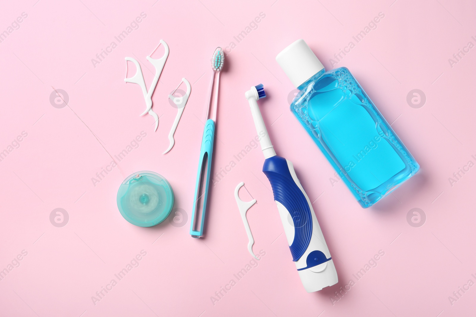 Photo of Flat lay composition with toothbrushes and oral hygiene products on color background