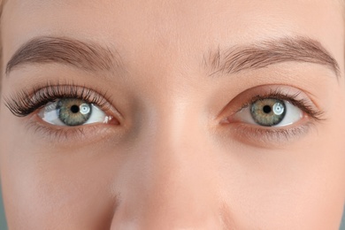 Photo of Young woman with beautiful eyelashes, closeup. Before and after extension procedure