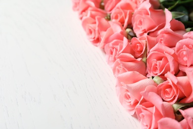 Beautiful roses on wooden table