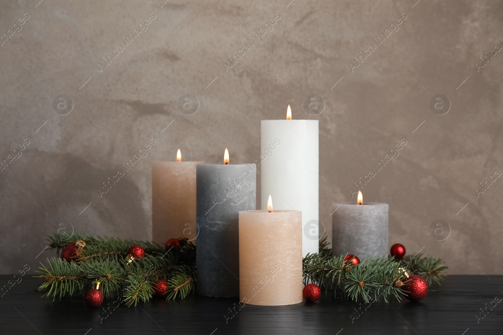 Photo of Burning candles with Christmas decoration on table