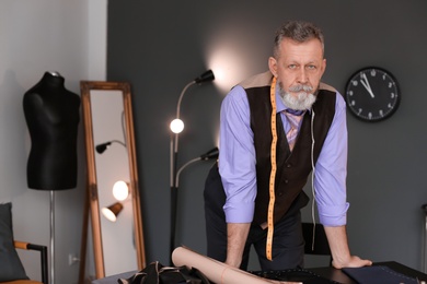 Photo of Portrait of mature tailor in atelier