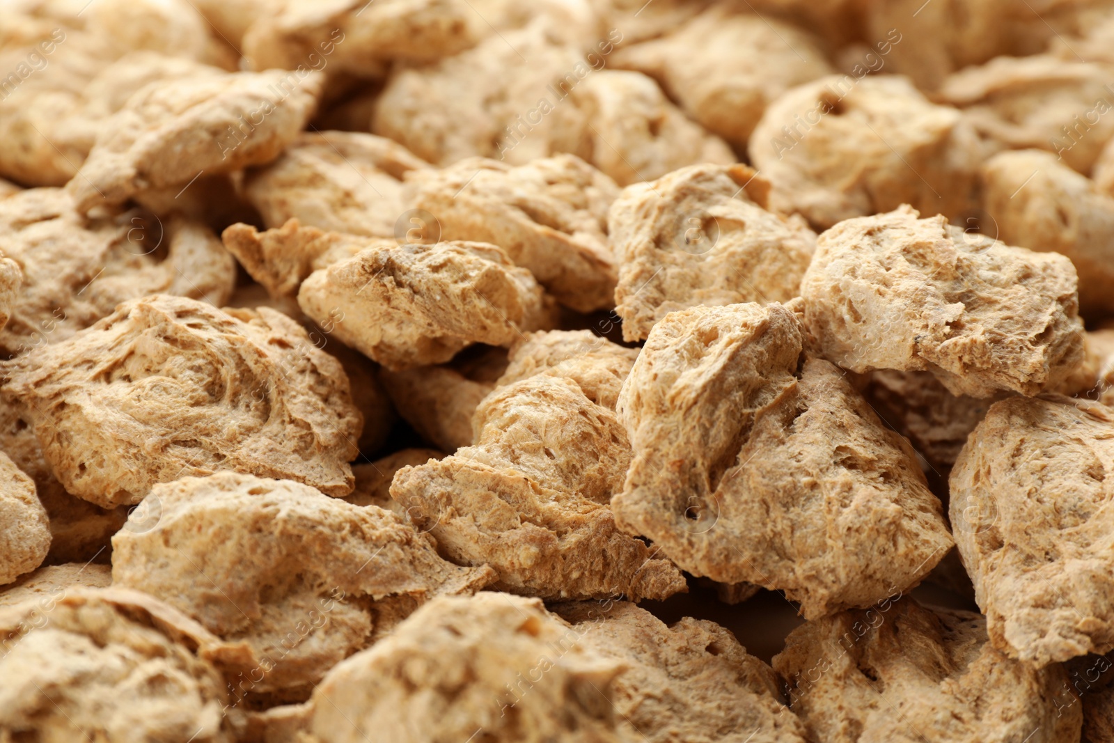 Photo of Dehydrated soy meat chunks as background, closeup