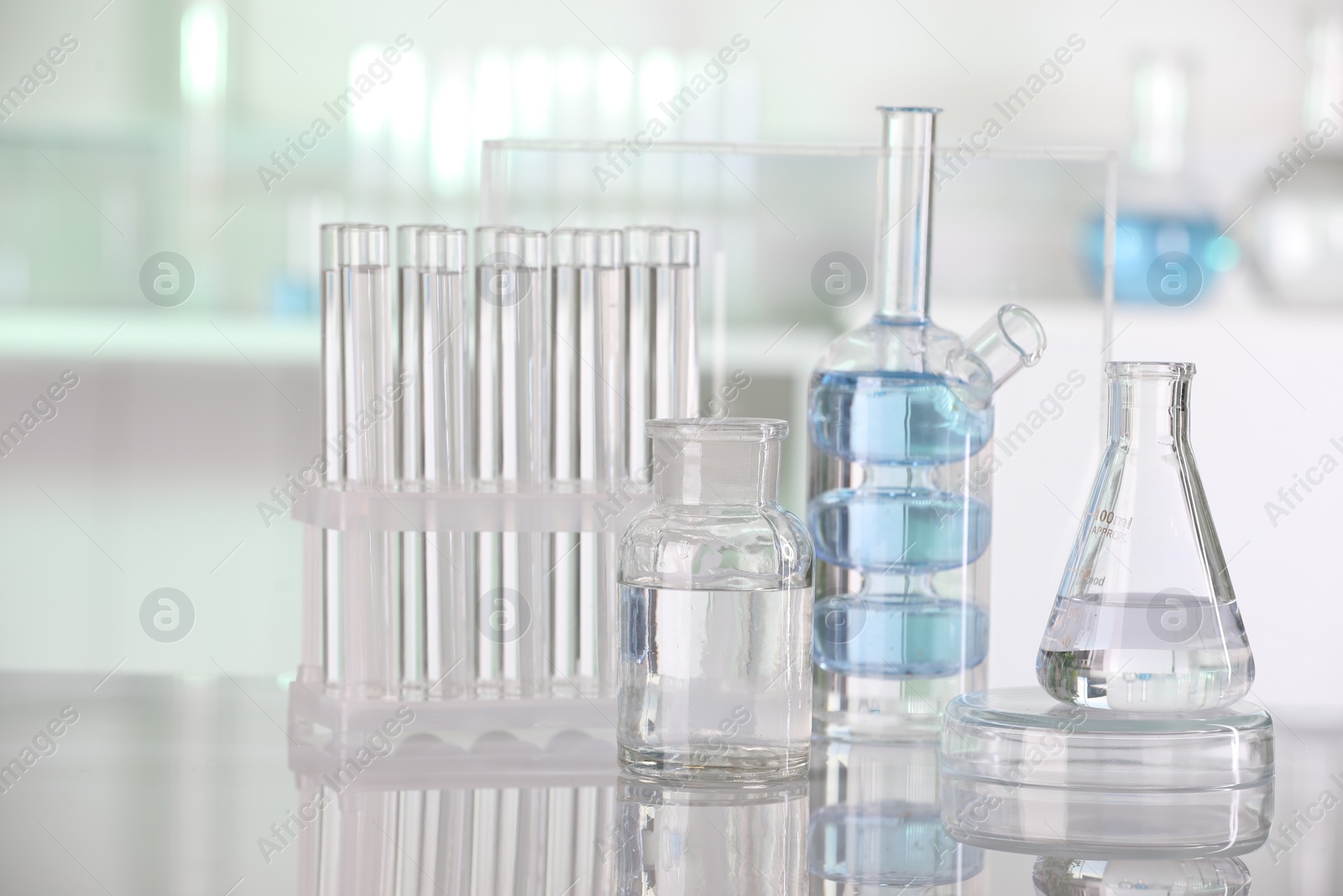 Photo of Laboratory analysis. Different glassware with liquid on white table indoors