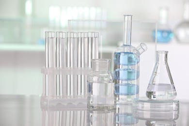 Laboratory analysis. Different glassware with liquid on white table indoors