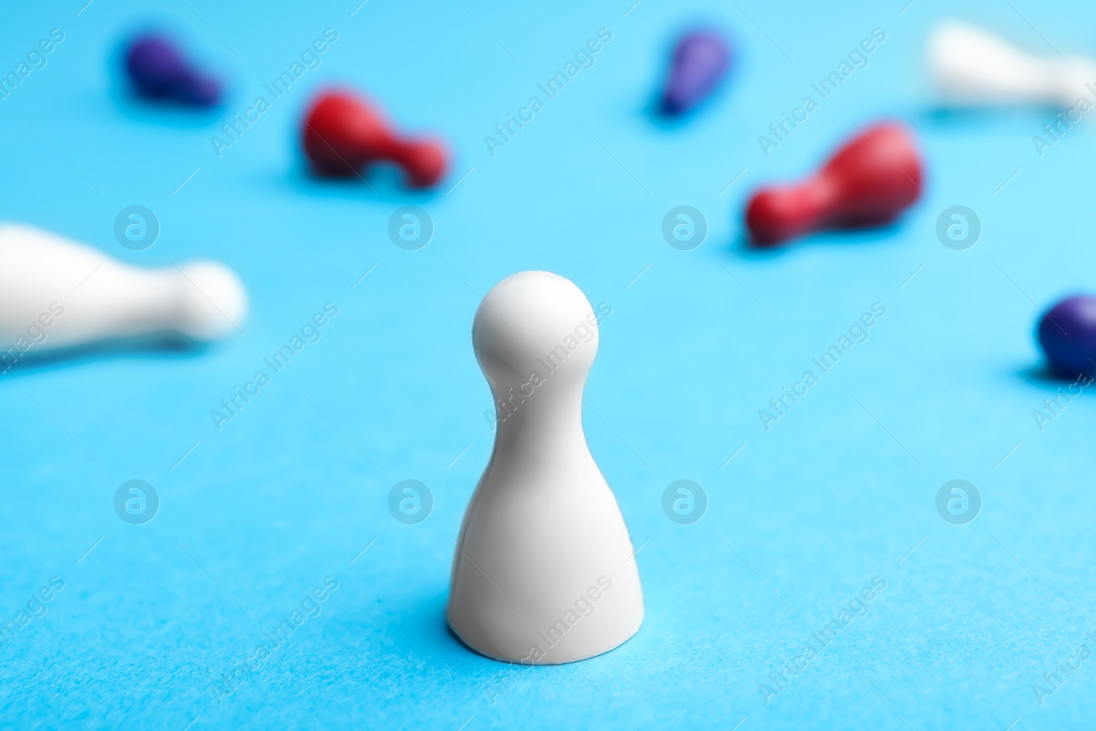 Photo of White pawn standing alone and other fallen down on table. Victory concept