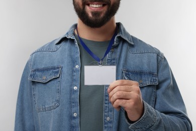 Photo of Man with blank badge on grey background, closeup