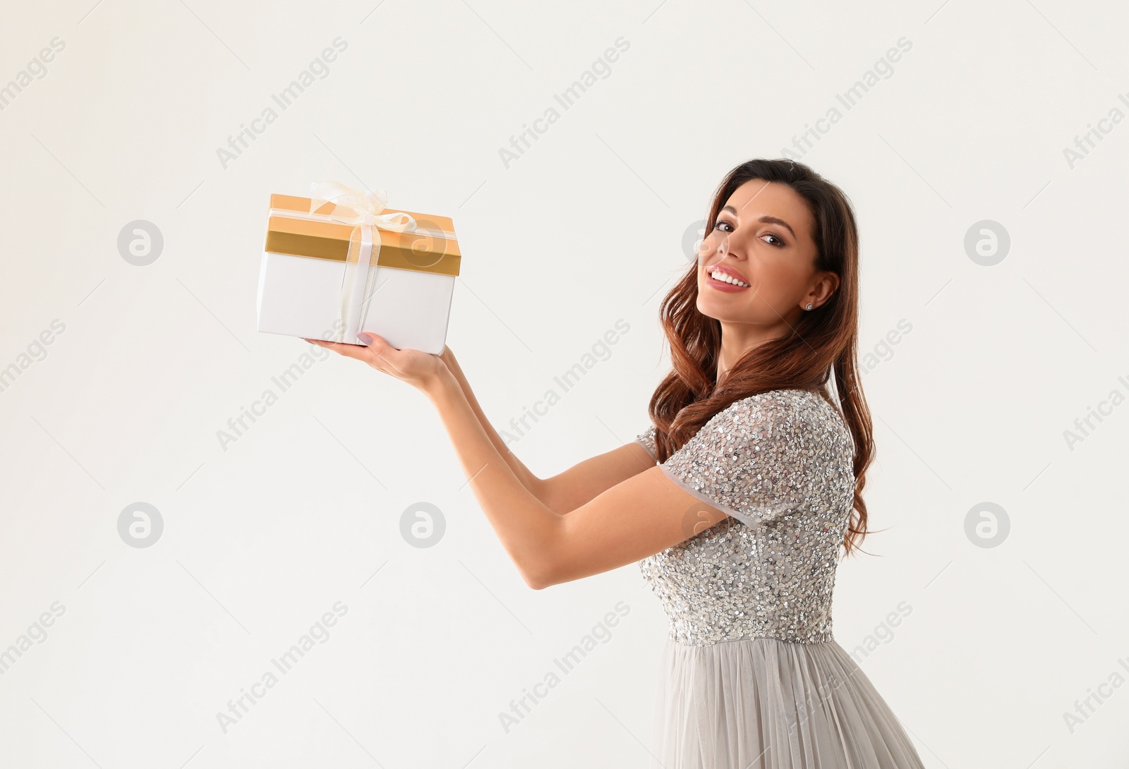 Photo of Beautiful woman with Christmas gift on white background