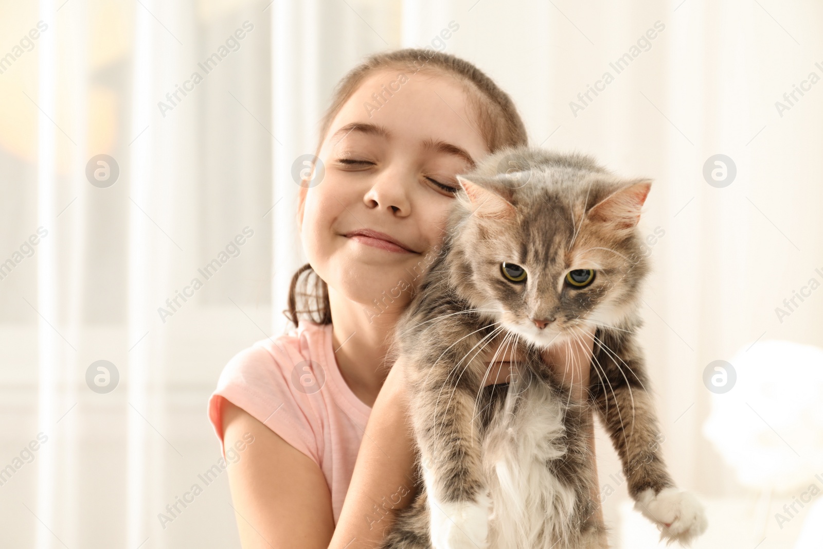 Photo of Cute little girl with cat at home. First pet