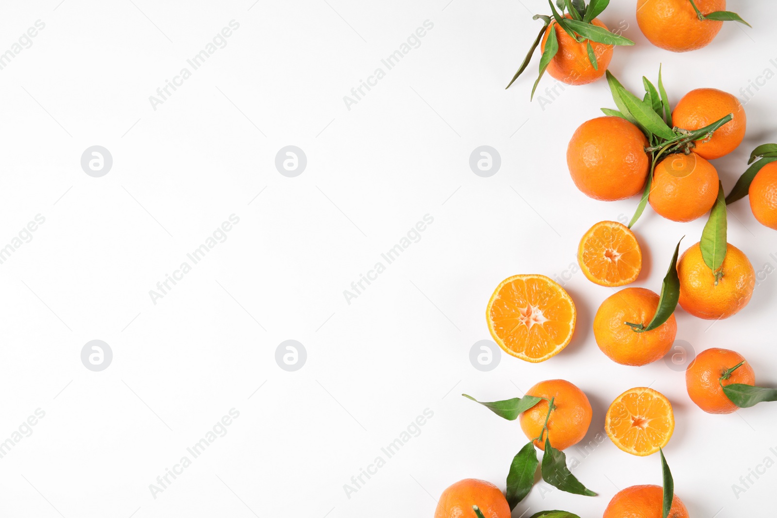 Photo of Flat lay composition with ripe tangerines on white background. Space for text