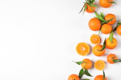 Flat lay composition with ripe tangerines on white background. Space for text