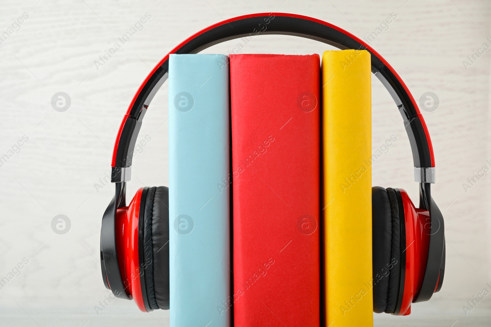 Photo of Books and modern headphones on white background, closeup