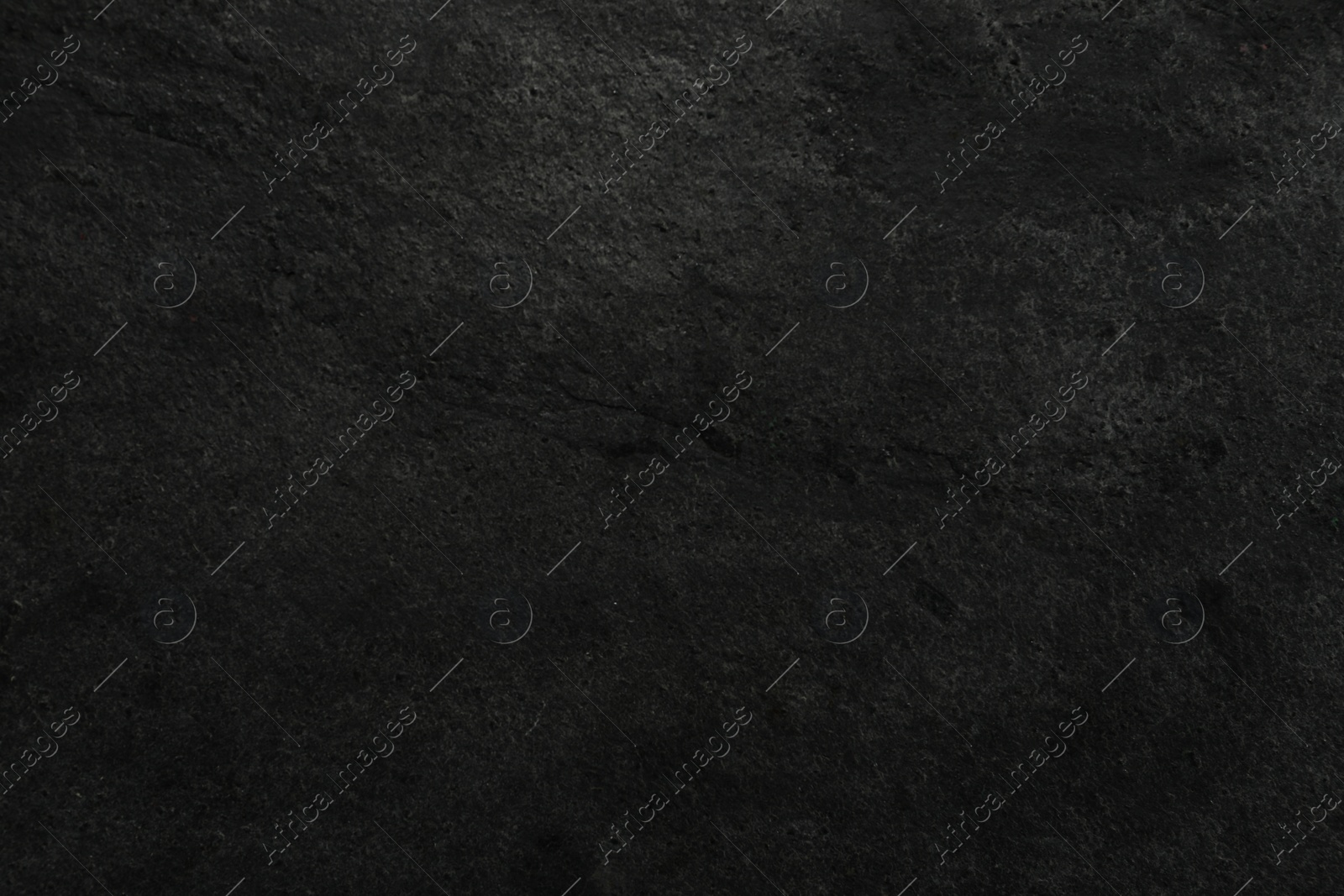 Photo of Texture of dark grey stone surface as background, closeup