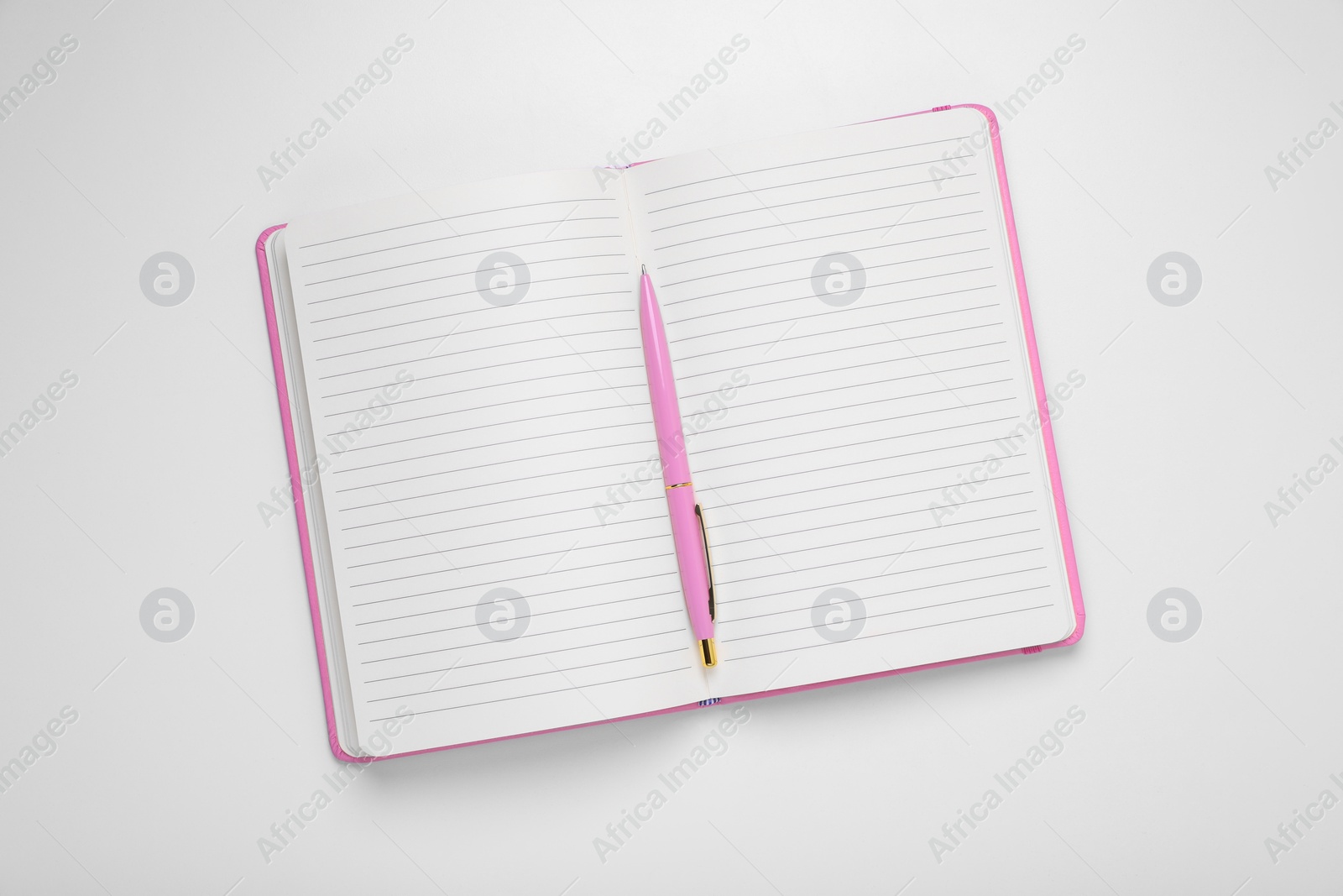 Photo of Open planner and pen on white background, top view