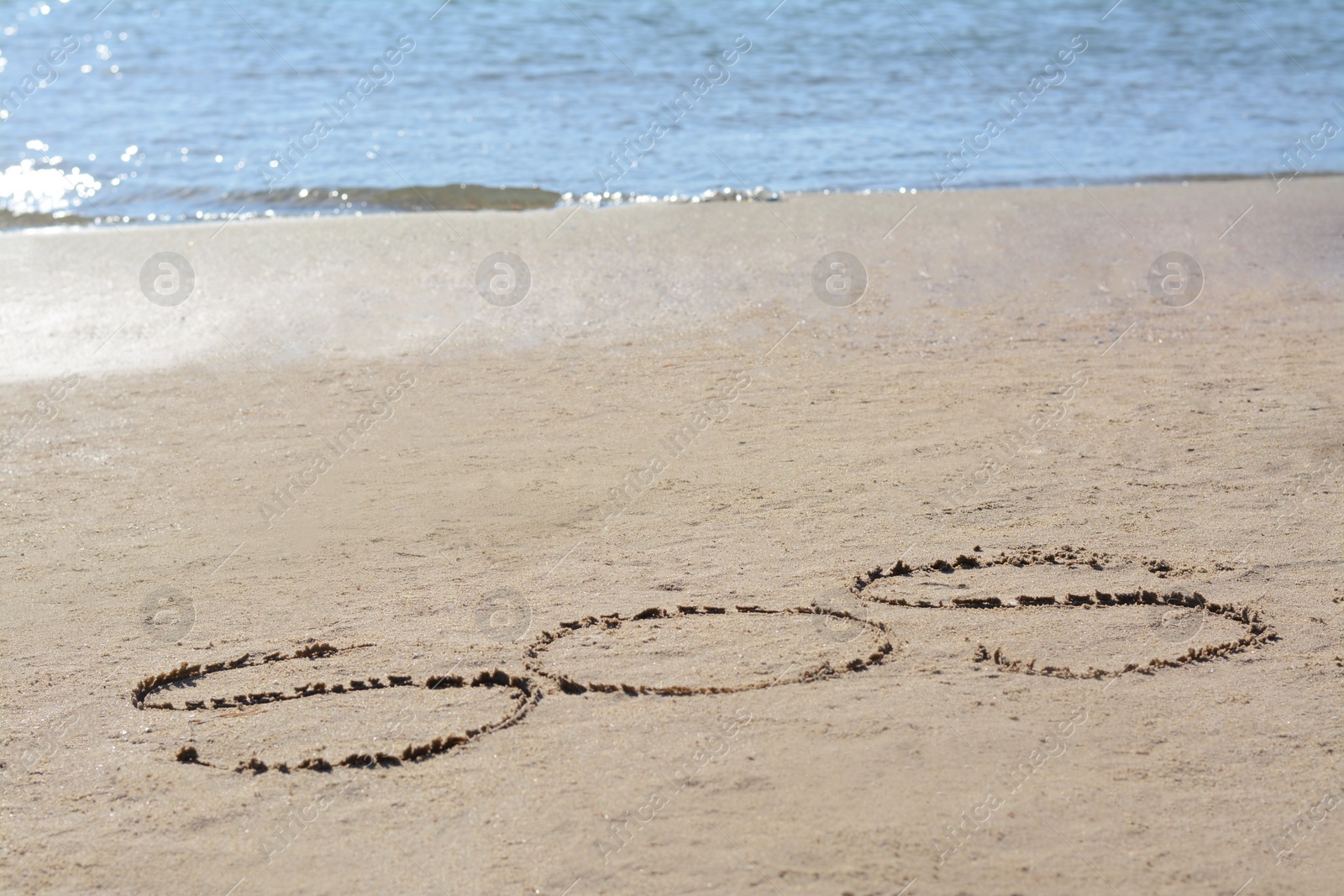 Photo of SOS message written on sand near sea