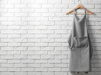 Photo of Clean kitchen apron with pattern on white brick wall. Space for text