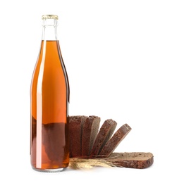 Photo of Bottle of delicious fresh kvass, spikelets and bread on white background