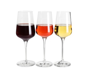 Glasses of different delicious expensive wines on white background