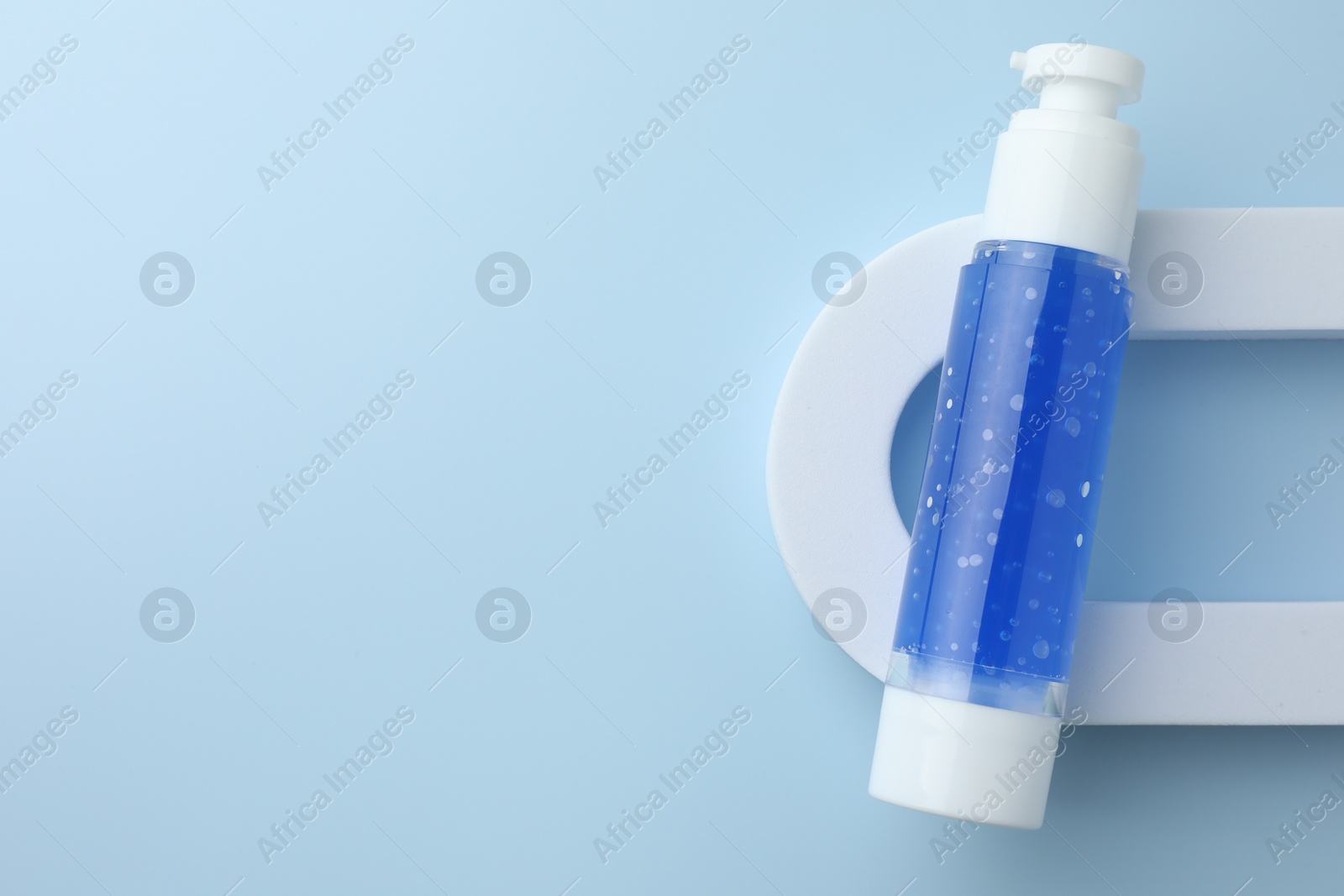 Photo of Cosmetic product on light blue background, top view. Space for text