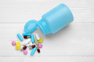 Photo of Different antidepressants and medical jar on white wooden table, flat lay
