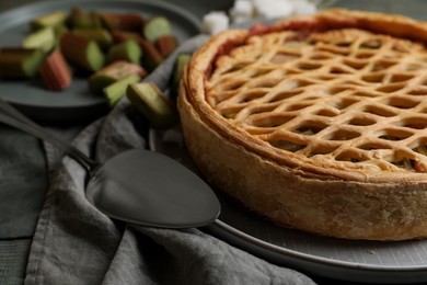 Photo of Freshly baked rhubarb pie and cake server on table, closeup
