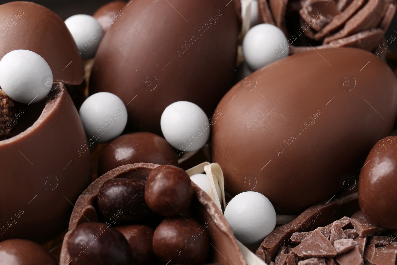 Photo of Tasty chocolate eggs and sweets as background, closeup