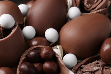 Photo of Tasty chocolate eggs and sweets as background, closeup