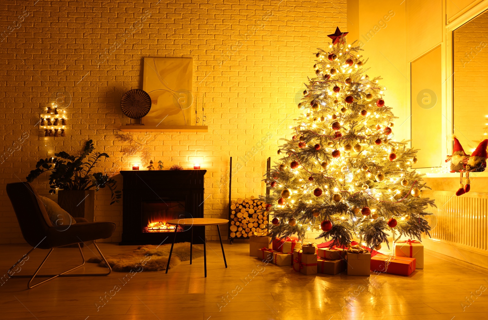 Photo of Beautiful Christmas tree and gifts near fireplace in room. Interior design