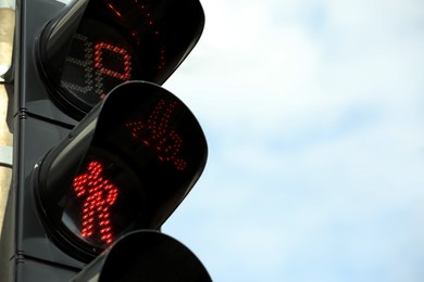 Photo of Closeup view of traffic light against blue sky. Space for text