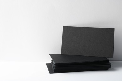 Photo of Blank black business cards on white background. Mockup for design