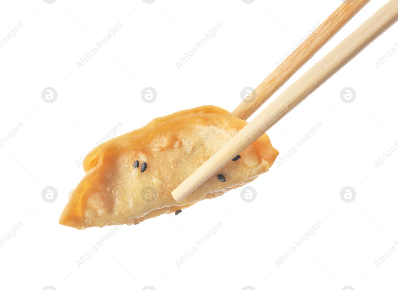 Photo of Chopsticks with delicious gyoza (asian dumpling) and sesame isolated on white