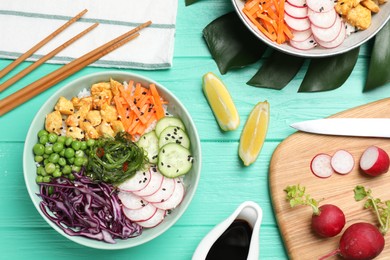 Photo of Delicious salad with chicken and vegetables on turquoise wooden table, flat lay