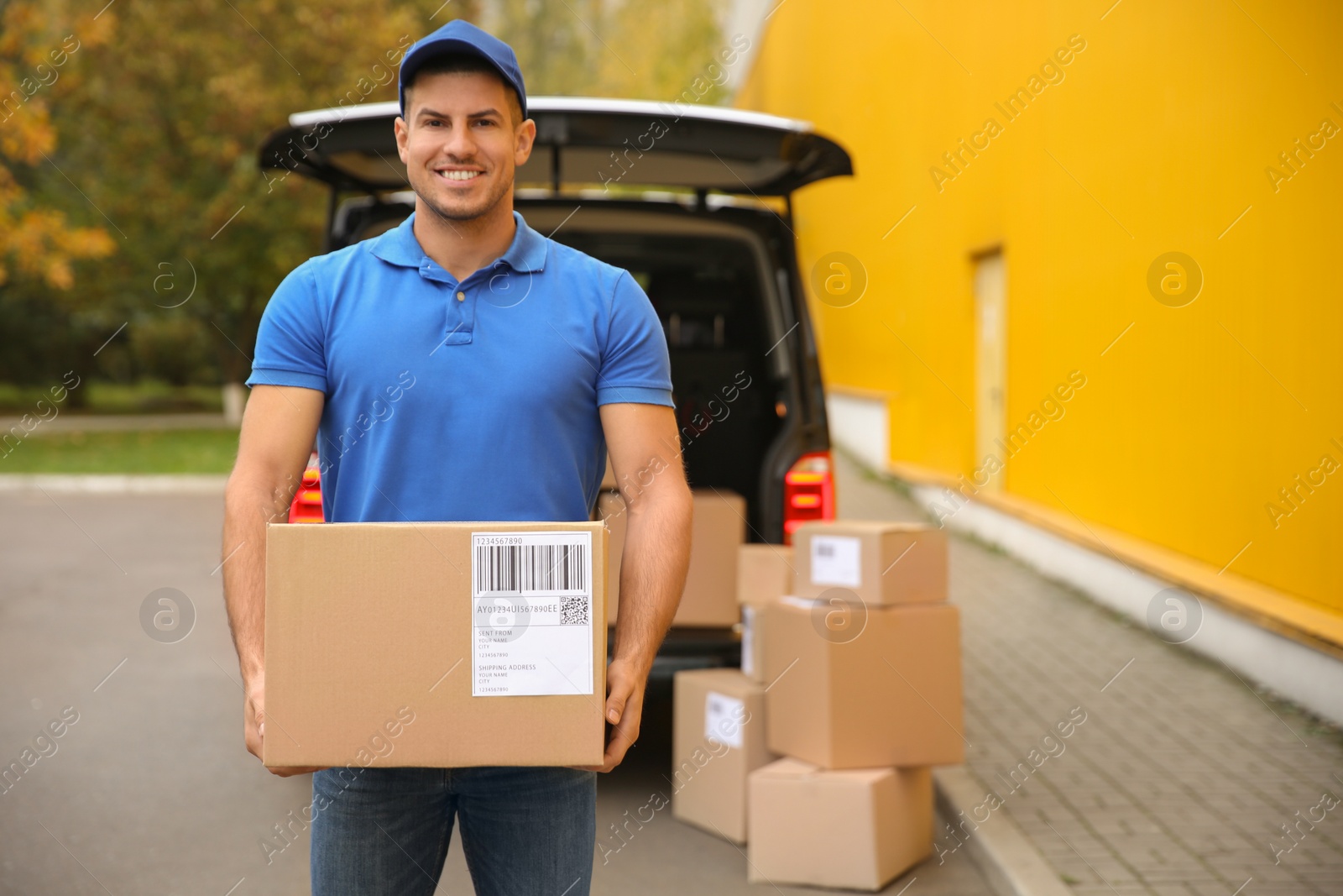 Photo of Courier with parcel near delivery van outdoors. Space for text