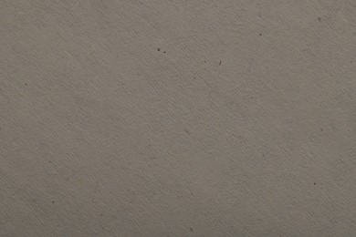 Photo of Texture of light grey paper sheet as background, top view