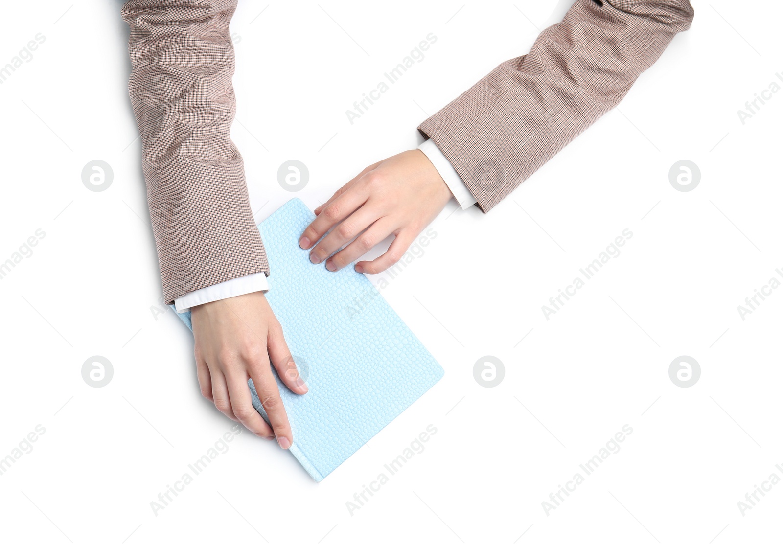 Photo of Woman with notebook on white background, top view. Closeup of hands