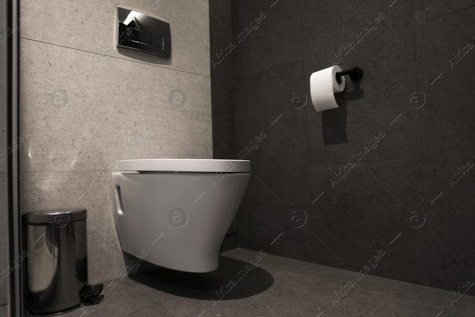 Photo of New modern toilet bowl in bathroom interior. Space for text