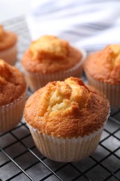 Delicious sweet muffins on grey table, closeup. Space for text