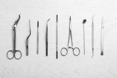 Photo of Flat lay composition with medical objects on white wooden background