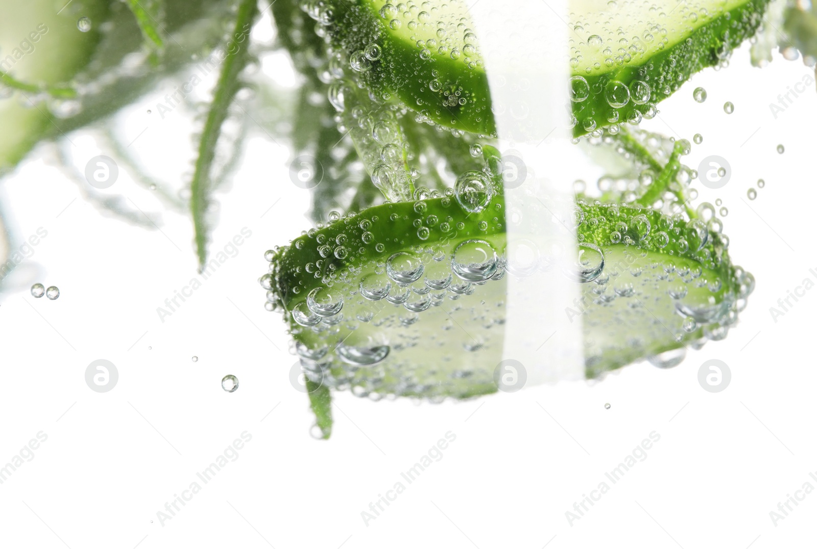 Photo of Refreshing cucumber water with bubbles isolated on white, closeup