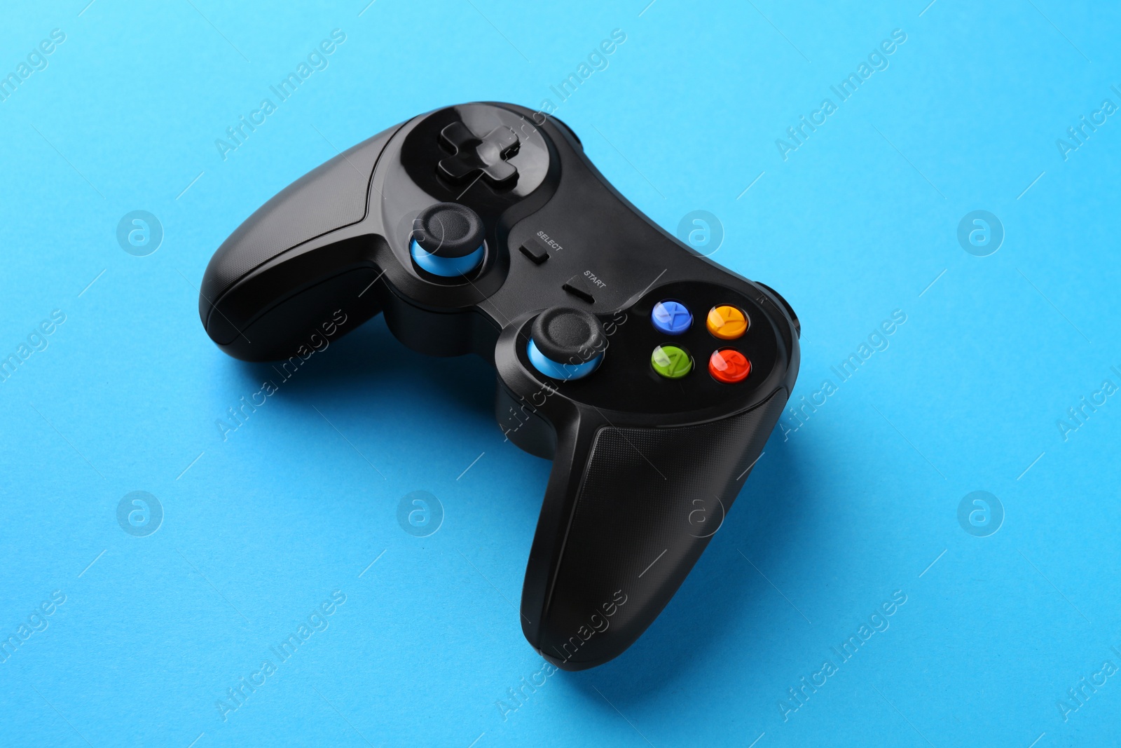 Photo of Wireless game controller on light blue background