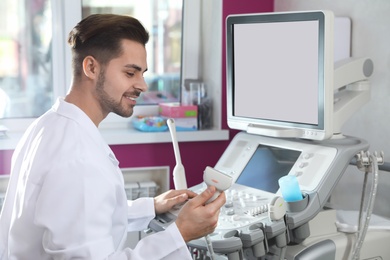 Photo of Sonographer using modern ultrasound machine in clinic