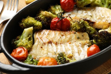 Photo of Tasty cod cooked with vegetables in baking dish, closeup