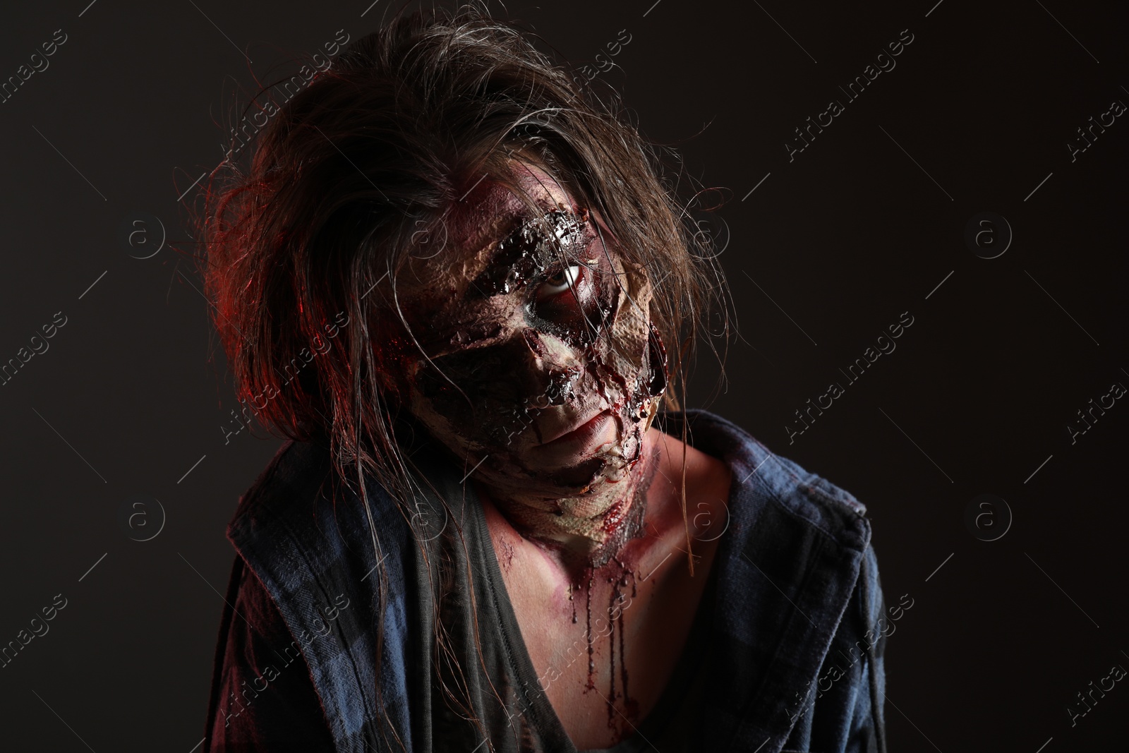 Photo of Scary zombie on dark background. Halloween monster